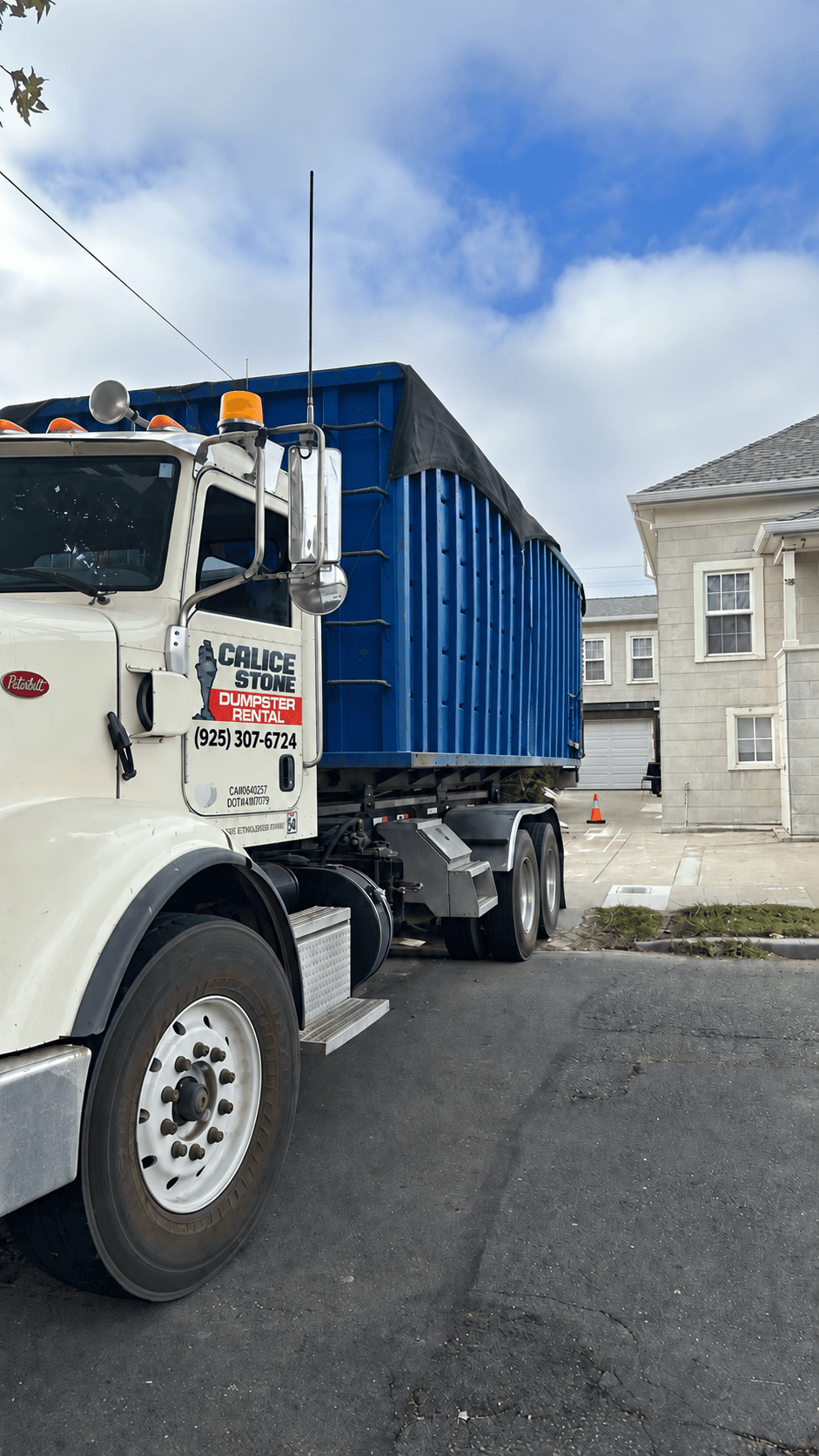 Calice Stone dumpster truck delivering a roll-off dumpster in the Bay Area