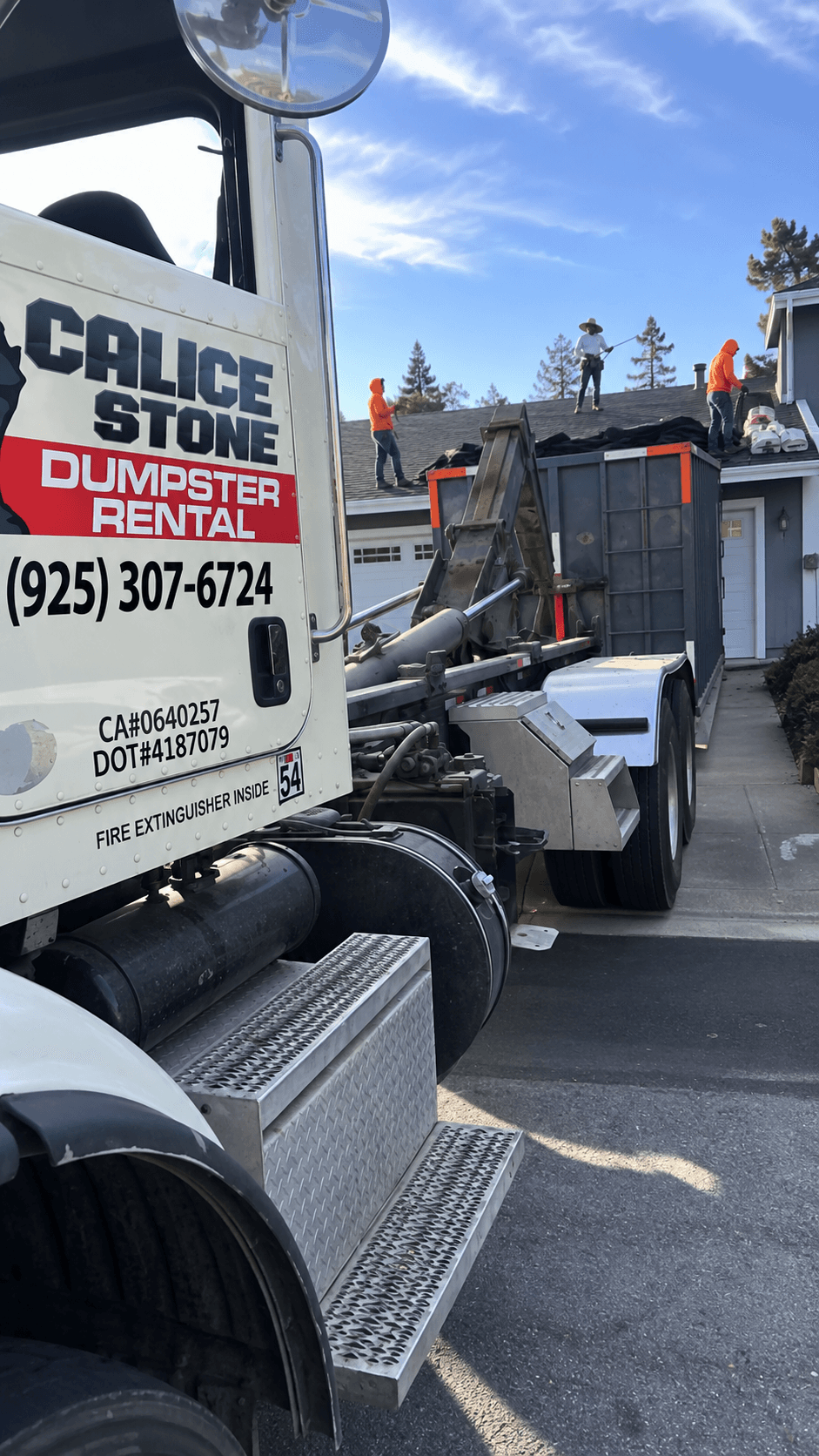 Calice Stone dumpster supporting a roofing crew at a residential job site